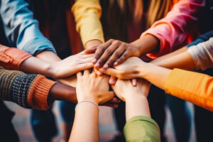 homosexual diverse group of young people stacking hands. lgbtq+ support and acceptance. diverse queer people holding hands.